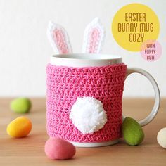 a crocheted coffee mug with bunny ears on it