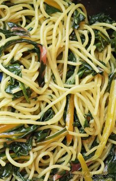 pasta with spinach and peppers in a pan