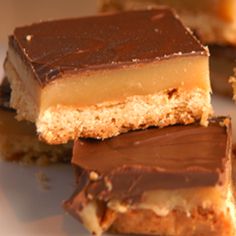 several pieces of chocolate and peanut butter bars on a plate