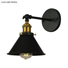 a black and gold wall light with a white background