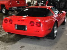 a red sports car parked in a garage