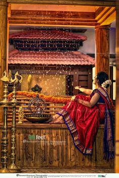 a woman sitting on top of a wooden bench