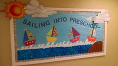 a bulletin board with paper boats on it and the words sailing into presch school