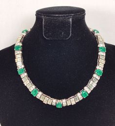 VTG CINER Silver Tone Green Faux Emerald Rhinestone Necklace Stunning. There’s one missing small square clear rhinestone(see last photo). It measures approx 14” long 3/8” wide Stamped CINER Weights 82 grams Thanks for looking!