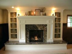 a living room with a fire place and bookcases