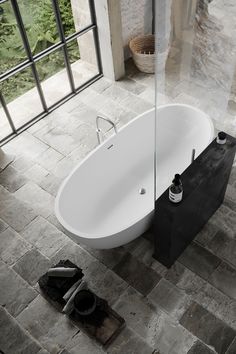 a bath tub sitting on top of a stone floor