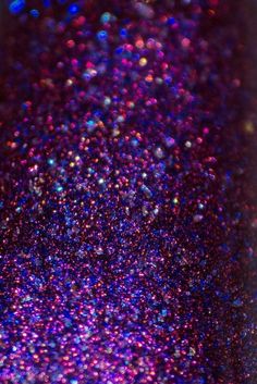 purple and blue glitter is seen in this close up shot from the bottom half of a cell phone