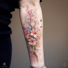 a woman's arm with flowers and butterflies painted on the side of her body