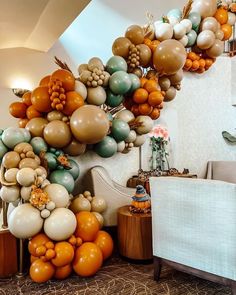 a bunch of balloons that are hanging from the side of a wall in a living room