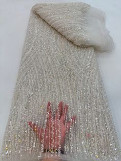 This high quality Fabric is measured in 5 Yards With Embroidered Beading and Sequin. It is soft, very delicate and beautiful. This high Quality Fabric is made with Fashion embroidered rhinestones can be used in making party wedding dresses, skirts, shawls, scarves and other other fashion apparels as you would like. Size : Length : 5 yards (180 inch). Width: 50 inch (Please allow slight deviation for the measurement data ,±1 inch) Material: 100% Polyester, Tulle Lace Fabric, Eco-Friendly embroide Elegant Embellished Fitted Tulle Fabric, Elegant Tulle Fabric With Pearl Embroidery For Party, Elegant Pearl Embroidered Tulle Fabric For Party, Elegant White Embellished Sequin Fabric, Elegant Fitted Tulle Fabric With Pearl Embroidery, White Fitted Sequin Fabric With Rhinestones, Fitted White Sequin Fabric With Rhinestones, Elegant Tulle Fabric With Sequins For Banquet, Elegant Sequined Tulle Fabric For Banquet