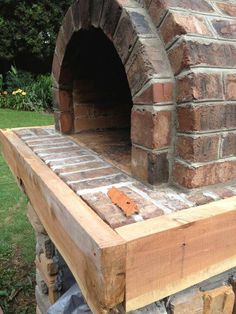 an outdoor brick oven built into the side of a building