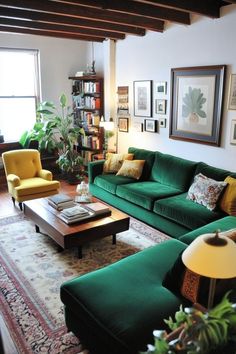 a living room filled with green couches next to a table and bookshelf