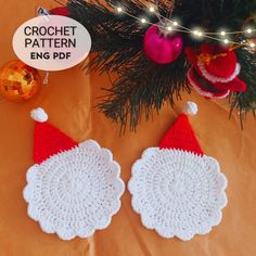 two crocheted santa hats hanging from a christmas tree with ornaments around it and the words crochet pattern engg pdf below