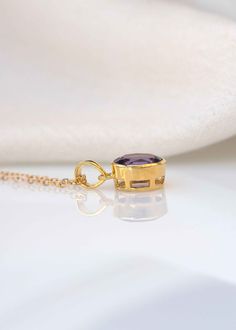 "Add a hint of color to your jewelry collection with our classic oval Amethyst gold necklace handmade in .925 silver base. This classic with a touch of modern necklace features a single 11mm x 9mm deep purple genuine amethyst set in a sturdy bezel setting. Comes with flat cable chain to create a unique look in the length of your choice. DIMENSIONS: Stone - 11mm x 9mm Diameter, Pendant total length 20mm Model is wearing 20\" long chain MATERIAL: 925 sterling silver, natural genuine amethyst stone Classic Oval Amethyst Necklaces, Classic Amethyst Oval Pendant Necklace, Timeless Gold Jewelry With Amethyst, Timeless Gold Amethyst Jewelry, Classic Amethyst Necklace For Gift, Gold Amethyst Jewelry With Polished Finish, Amethyst Pendant Necklace, Amethyst Set, Modern Necklace