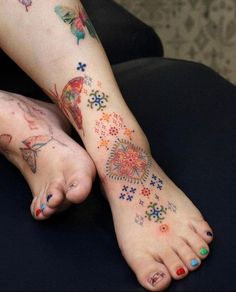 a woman's foot with tattoos on it