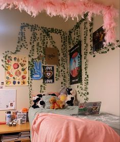 a bedroom decorated in pink and white with lots of decorations on the wall above the bed