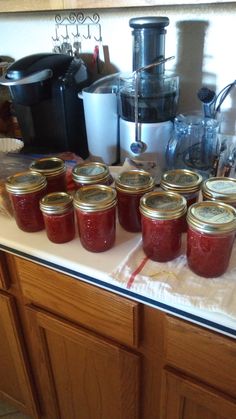 many jars of jam sit on the counter top