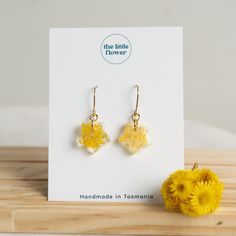 - Yellow Flower Star Earrings | Resin Earrings | Dried Flowers | Real Flower Jewellery | Floral Fashion | Natural Jewellery - Handmade Dainty Flower Dangle Earrings made from yellow Common Everlasting flowers. As part of our new collection the Dainty Flower Dangles are made with real flowers encased in resin to give them a lasting effect. These stunning natural flower earrings are a perfect, timeless gift to give to those you love, as the colours of the dried flowers are preserved in a way that keeps them alive and vibrant for all to enjoy. Our floral earrings are all handmade in the small Island state of Tasmania using locally grown flowers. Findings made from quality golden stainless steel. *please store earrings out of direct sunlight to preserve their pigment* To find out more about ou Yellow Flower-shaped Earrings With Pressed Flowers, Yellow Flower Earrings With Pressed Flowers, Yellow Birth Flower Earrings, Yellow Flower Earrings With Birth Flower Detail, Real Flower Jewellery, Flowers Real, Everlasting Flowers, Real Flower Jewelry, Earrings Resin