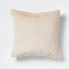 a white pillow with a light colored fur texture on the front and back of it