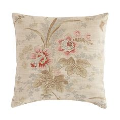 an embroidered pillow with pink flowers and leaves on the front, sitting on a white background