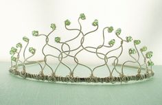 This glittery tiara is waiting to be made just for you!  The shiny art wire is shaped and twisted to form a lacy, organic crown.  Each end is adorned with a vibrant Swarovski crystal in whatever color (or colors!) you choose.  Silvery wire and Peridot crystals are the shades shown, but you can choose any from the charts. This small tiara is about 2 inches high at the center and about 6 inches across the arc.  It is attached to a sturdy metal headband and feature loops on the inside front to help hold it in place.  Please specify your color choices in the Message to Seller during check out.  Please allow about 3 weeks for crafting before shipping.  I will send you a message when I receive your order to provide a more accurate time line for making your tiara.  I will message you again when I Wire Tiara, Candy Crown, Small Tiara, Diy Tiara, Weaving Wire, Wire Crown, Quinceanera Crown, Wire Craft, Crystal Colors