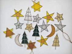 an assortment of christmas decorations made out of wood and glass stars, moon, and trees