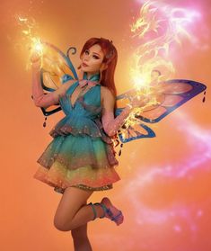 a woman dressed as a fairy holding a butterfly