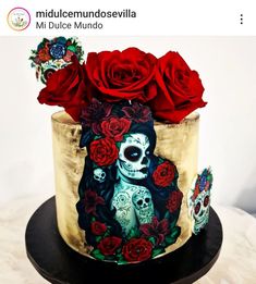 a cake decorated with sugar skulls and red roses