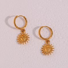 Brighten your day with our radiant with the Sun Goddess Earrings, beautifully crafted in 18k gold. These earrings feature a stunning sun charm that captures the essence of celestial beauty and modern sophistication. Tarnish-free and lightweight, they are perfect for adding a touch of shine to any outfit. Material: 316L Stainless Steel, 18k gold finish Weight: 3g/pair Unique sun charm design Tarnish-free and lightweight Waterproof, Hypoallergenic Celestial Style Gold-plated Yellow Gold Hoop Earrings, Celestial Style Yellow Gold Plated Hoop Earrings, Celestial Tarnish-resistant Earrings For Everyday, Celestial Style Tarnish Resistant Earrings, Celestial Yellow Gold Tarnish-resistant Hoop Earrings, Elegant Sunburst Earrings As A Gift, Celestial Yellow Gold Earrings Tarnish Resistant, Celestial Yellow Gold Plated Earrings, Gold Sun-shaped Earrings For Gift