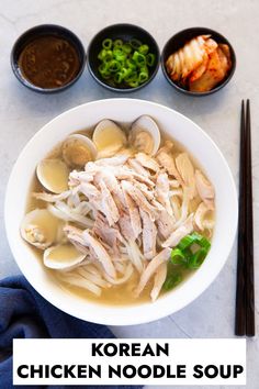 a bowl of chicken noodle soup with chopsticks on the side