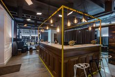 the interior of a restaurant with bar stools and lights hanging from the ceiling over the counter