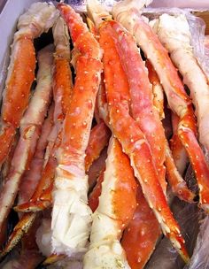 several large crabs in plastic bags sitting on top of each other, ready to be eaten