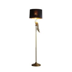 a floor lamp with a black shade on the top and a white light behind it