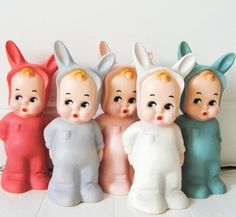 a group of little figurines sitting next to each other on a white tile floor