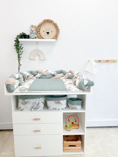 a baby's crib in the corner of a room with shelves and toys