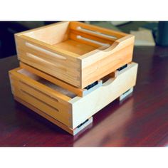 three wooden boxes stacked on top of each other