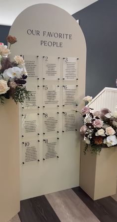 a display with flowers on it in front of a sign that says our favorite people