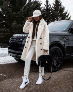 Winter outfit ideas Similar topshop shearling coat Nordstrom white sweatsuit Nike blazer sneakers Nike cap #LTKstyletip #LTKSeasonal #LTKunder100 High Tops Women Outfit, Nike White High Tops Outfits, Sneakers In Winter Outfit, New York Sweatshirt Outfit, Winter White Sneakers Outfit, High Top Nikes Womens Outfit, White Sherpa Coat Outfit, Puma High Top Sneakers Outfit, High Top White Sneakers Outfit