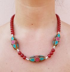 This necklace was made with carnelian beads, Tibetan silver spacers and three Indian pendants made with turquoise paste and coral paste. The closure is a magnet. Carnelian has always been considered the symbol of life, much appreciated by the ancient Romans. It gives joie de vivre, optimism, vitality, courage and strength; it also counteracts negative feelings such as hatred, envy and jealousy. This necklace is made of carnelian beads, Tibetan silver spacers and three Indian charms made of turqu Traditional Beaded Necklace With Red Coral And Natural Stones, Red Carnelian Amulet Necklace, Red Amulet Necklace With Gemstone Beads, Bohemian Carnelian Necklace With Colorful Beads, Handmade Red Carnelian Beaded Necklaces, Traditional Turquoise Beaded Necklaces With Spacer Beads, Traditional Carnelian Necklace With Colorful Beads, Traditional Turquoise Beaded Necklace With Spacer Beads, Bohemian Beaded Necklaces With Red Coral