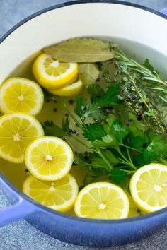 lemons, herbs and water in a blue pot