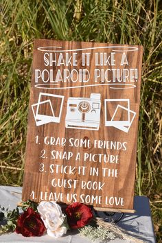 a sign that says shake it like a polaroid picture on top of a table