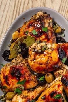 grilled chicken with olives and capers on a plate