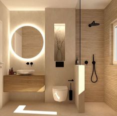 a bathroom with a sink, toilet and shower in it's center wall is illuminated by round mirrors