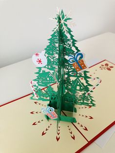 an origami christmas tree on top of a card