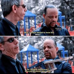 two men talking to each other in front of a playground