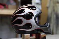 a motorcycle helmet sitting on top of a wooden block