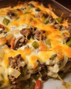 a casserole dish with meat, cheese and peppers on it is ready to be eaten