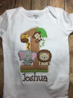 a baby's first birthday shirt with an elephant and giraffe on it