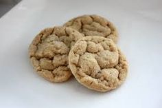 two cookies sitting on top of a white table