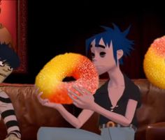 two cartoon characters sitting on a couch with donuts in their hands and one is holding an orange frosted donut